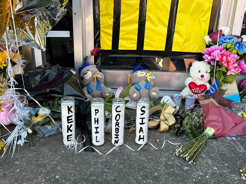 Candles with the names of four people killed in a mass shooting stand with toys and flowers in front of the dance studio where the shooting took place in Dadeville, Ala., on April 19. At least four people were killed and 32 injured at a Sweet 16 birthday party where the shooting took place. (Jemma Stephenson/Alabama Reflector)