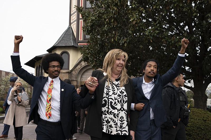 From left, then-expelled state Rep. Justin Pearson, D-Memphis; state Rep. Gloria Johnson, D-Knoxville; and then-expelled state Rep. Justin Jones, D-Nashville, raise their fists as they walk across the Fisk University campus after hearing Vice President Kamala Harris speak April 7 in Nashville. Harris came to support the two Democratic lawmakers who were expelled from the Tennessee General Assembly. Both were later reinstated. (AP Photo/George Walker IV)