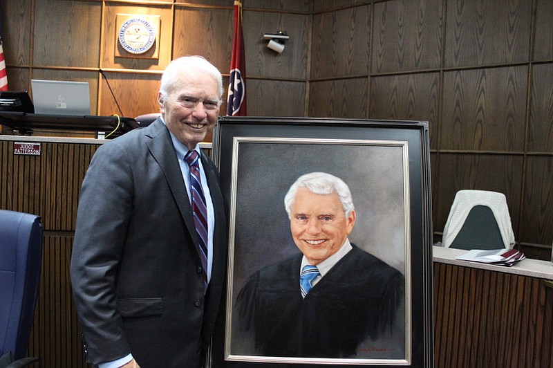 Staff Photo by La Shawn Pagán / Retired Judge Don W. Poole stands next to his portrait, which will hang in Division III of the Hamilton County Criminal Court.