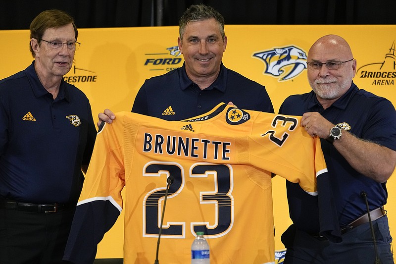 AP photo by George Walker IV / Nashville Predators founding general manager David Poile, left, new head coach Andrew Brunette and incoming GM Barry Trotz pose during a news conference Wednesday at Bridgestone Arena.