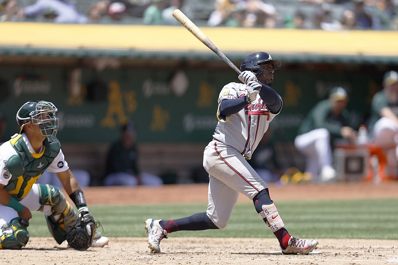 AP photo by Jed Jacobsohn / Ozzie Albie hits a two-run home run for the Atlanta Braves in front of Oakland Athletics catcher Carlos Perez during Wednesday's game in California. Albies put the Braves ahead for good as they avoided being swept in the three-game series.