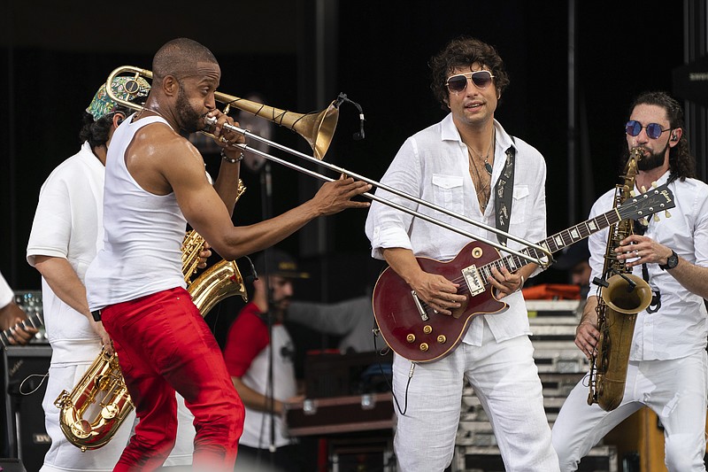 Trombone Shorty, left, and Pete Murano of Trombone Shorty & Orleans Avenue perform at the 2023 New Orleans Jazz & Heritage Festival on May 7, 2023, at the Fair Grounds Race Course in New Orleans. The band will headline the final day of the Riverbend Festival on June 4. / Photo by Amy Harris/Invision/AP