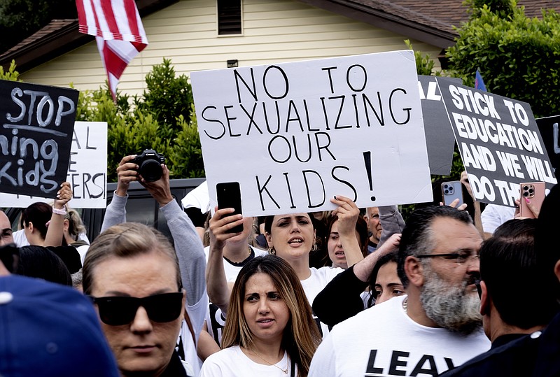 Photo/Richard Vogel/The Associated Press / Protesters shout slogans and carry signs as Los Angeles police officers separate them from counter-protesters at the Saticoy Elementary School in the North Hollywood section of Los Angeles on Friday, June 2, 2023.