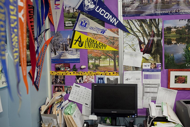 File photo/Andrew Spear/The New York Times / University and college pennants and posters adorn the counseling office of a high school in Brooklyn in December 2014. Universities are preparing for the possible end of race-conscious affirmative action.