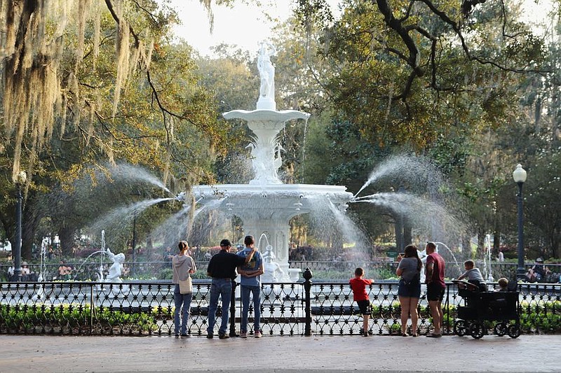 Visitors stand before the Forsyth Park fountain, one of Savannah's most popular tourist hotspots. / GPB photo