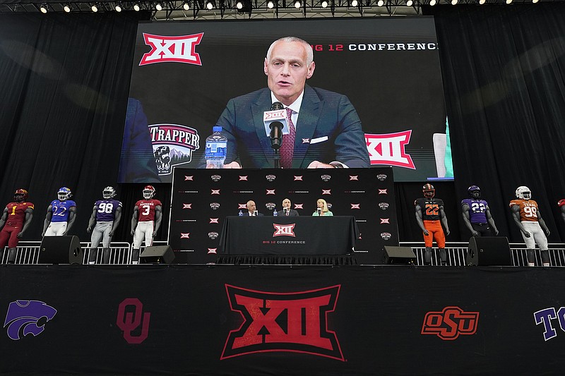 AP photo by LM Otero / Big 12 commissioner Brett Yormark is shown on the big screen during the league's football media days event on July 13, 2022, in Arlington, Texas. The Big 12 will go from 10 teams to 14 next month with the addition of BYU, Cincinnati, Houston and UCF, but the conference will lose Oklahoma and Texas to the SEC in July 2024.