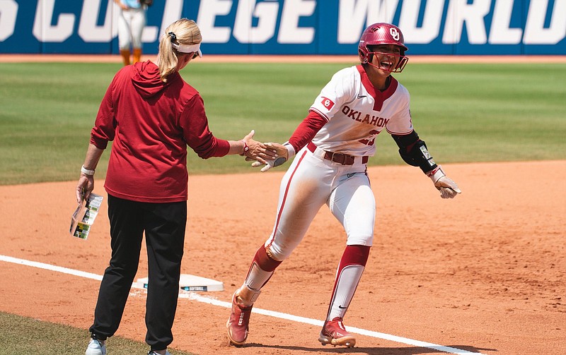 Oklahoma Athletics photo / Oklahoma's Tiare Jennings is all smiles rounding third base after her three-run home run in the second inning opened the floodgates to a 9-0 rout of Tennessee on Saturday at the Women's College World Series.
