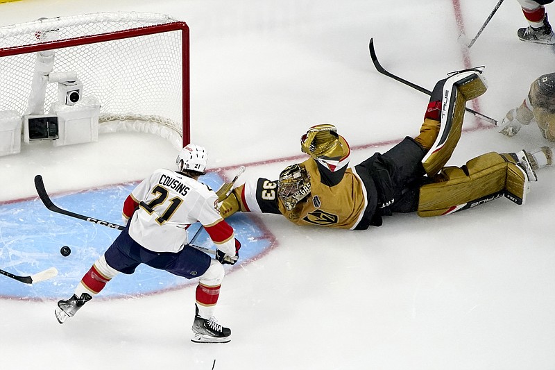 AP photo by John Locher / Vegas Golden Knights goaltender Adin Hill stretches out on the ice to block a shot by Florida Panthers center Nick Cousins (21) during the second period of Game 1 of the Stanley Cup Final on Saturday night in Las Vegas.