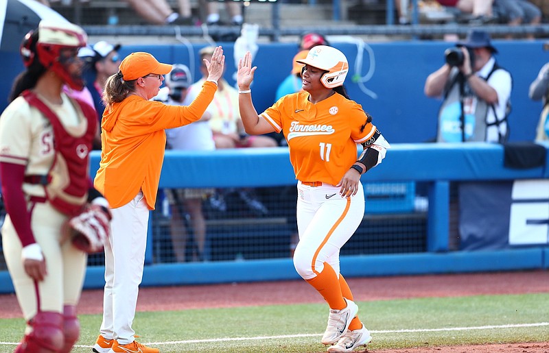 Tennessee Athletics photo / Tennessee coach Karen Weekly congratulates Zaida Puni after Puni's home run to center field provided the Lady Vols a 1-0 lead in the first inning of Monday night's semifinal in the Women's College World Series. The Lady Vols would be eliminated by Florida State 5-1.