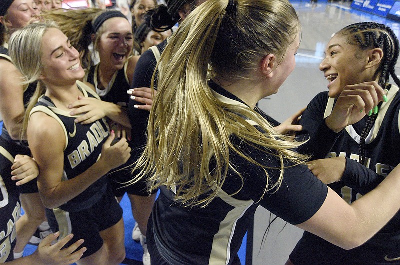 Staff photo by Matt Hamilton / Bradley Central players celebrate after Harmonie Ware, right, made the winning basket in a TSSAA Class 4A state quarterfinal on March 8 in Murfreesboro, Tenn.