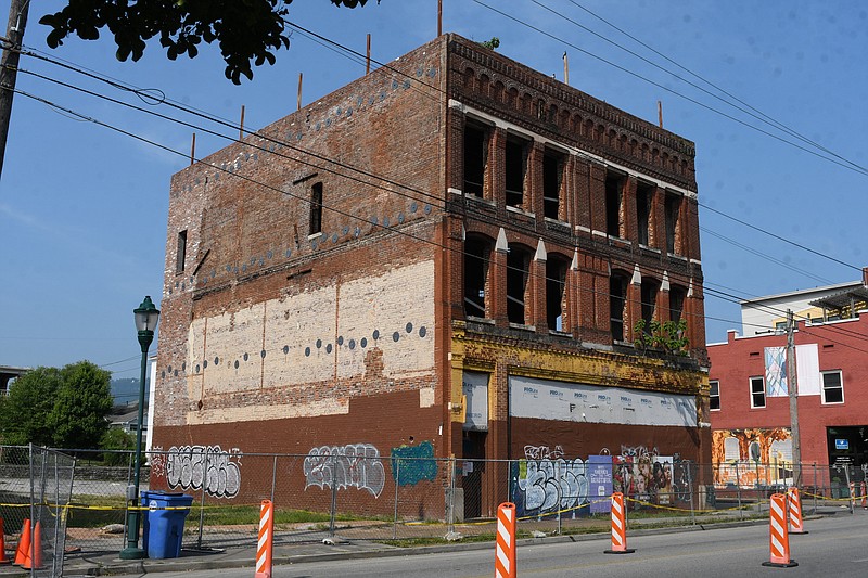 Staff Photo by Robin Rudd / East Main Street traffic is rerouted Wednesday as work begins on the demolition of the old Levin Brothers building. Demolition started Monday, requiring part of Main Street to be blocked off this week, according to a  news release. The Victorian-style structure has seen several failed attempts for renovation over several decades.