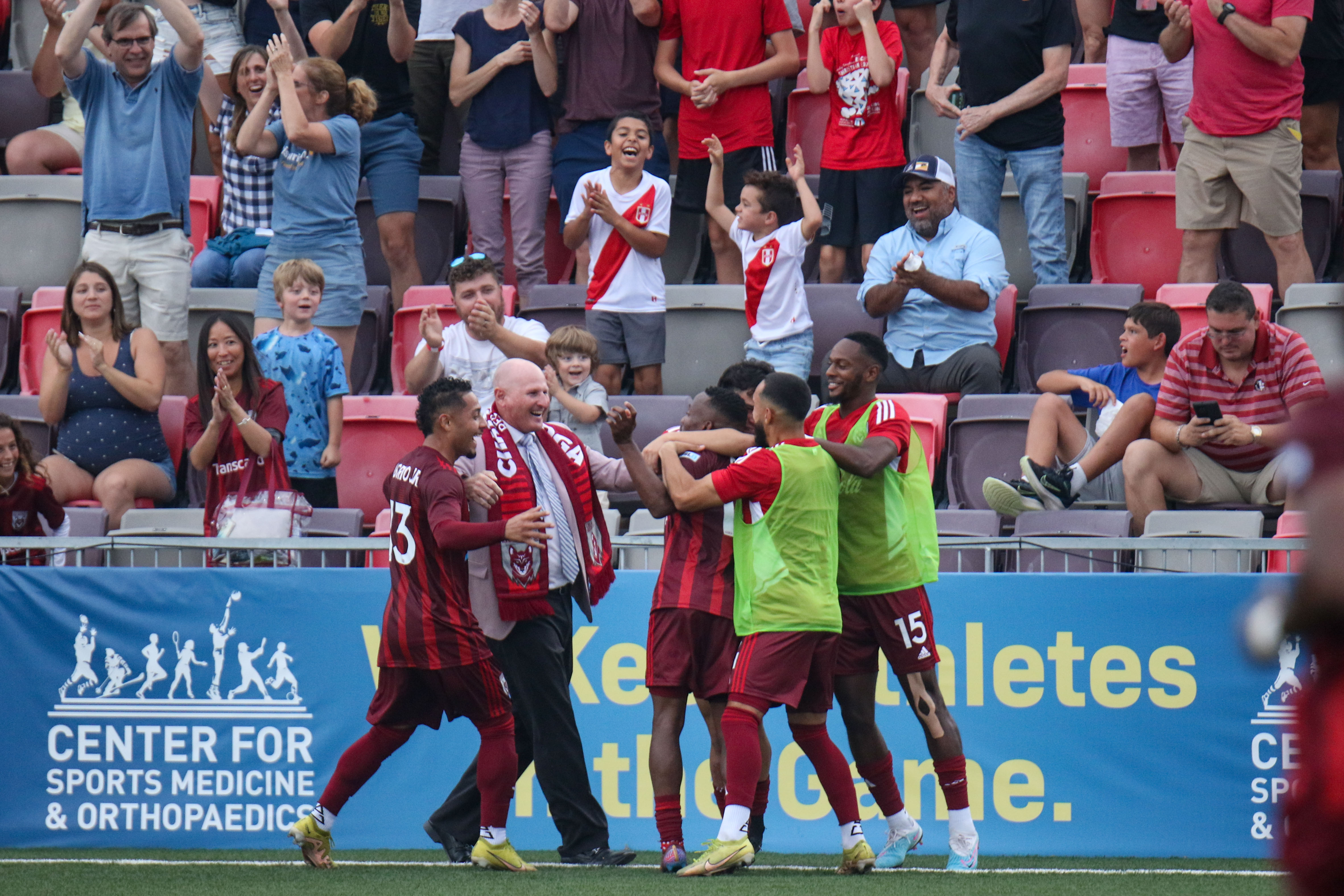 Staff photo by Olivia Ross / The Chattanooga Red Wolves celebrate and fans cheer after Chevone Marsh, center, scored near the end of the first half for a 2-0 lead against Forward Madison FC in a USL League One soccer match Wednesday night at CHI Memorial Stadium in East Ridge.