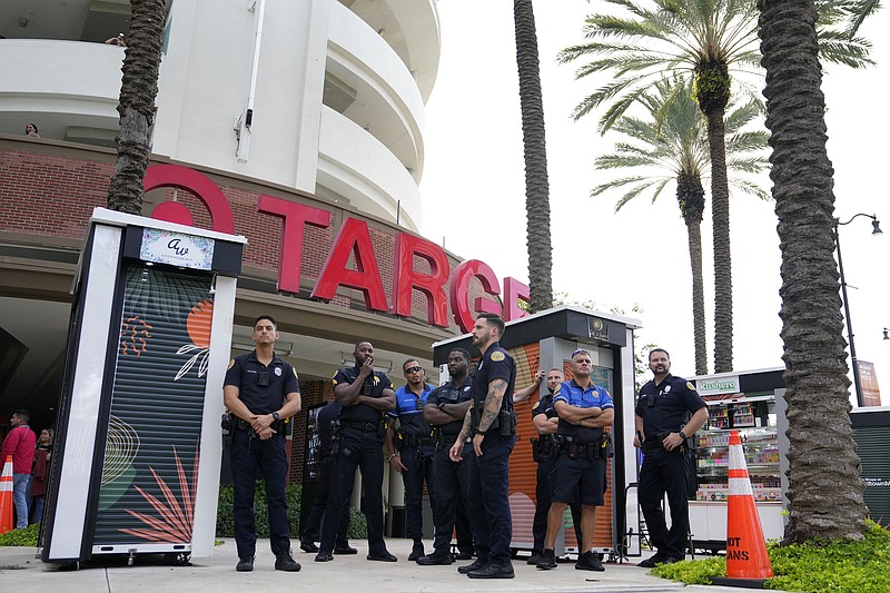File photo/Lynne Sladky / Police officers stand outside a Target store as a group of people protest across the street on Thursday, June 1, 2023, in Miami. Longtime Pride sponsors like Bud Light and Target have come under attack by conservatives for their LGBTQ-friendly marketing.