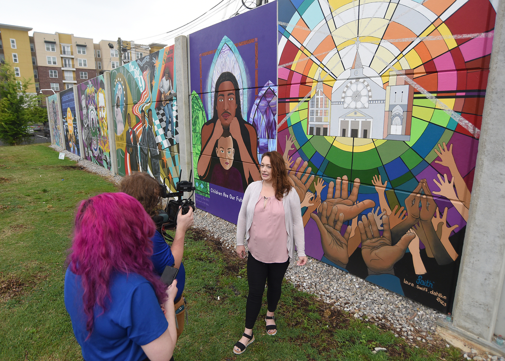 Staff Photo by Matt Hamilton / Laura Swift Dahlke stands in front of her mural for an interview during the EPB mural reveal Tuesday.