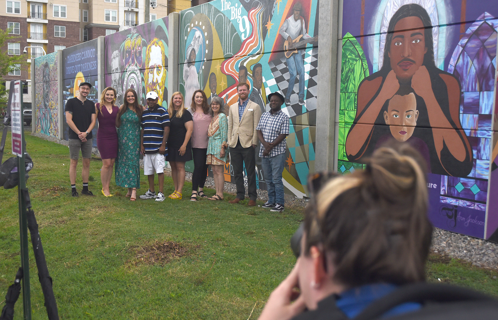 Staff Photo by Matt Hamilton / A photographer takes pictures of the mural artists during the EPB mural reveal Tuesday.