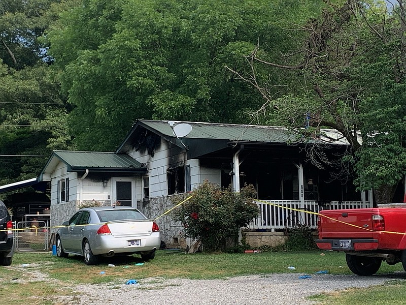 Staff Photo by Ellen Gerst / Six people were killed and the home set afire on Pine Street in Sequatchie, Tenn., during the night of June 15. The scene was photographed on June 16.