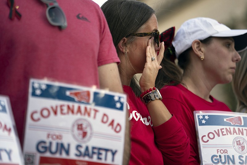 Covenant School parent Lori Buck wipes away tears during a demonstration for gun control legislation April 18 in Nashville. Participants created a human chain spreading from Monroe Carell Jr. Children's Hospital at Vanderbilt, where victims of The Covenant School shooting were taken March 27, to the Tennessee State Capitol. (AP Photo/George Walker IV)
