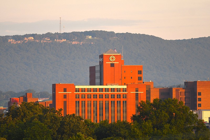 Staff Photo by Robin Rudd / The rising sun illuminates the Erlanger Baroness Campus and Baroness Hospital on Aug. 23, with Elder Mountain serving as a backdrop. The Baroness Hospital is one of six in the Erlanger Health System.