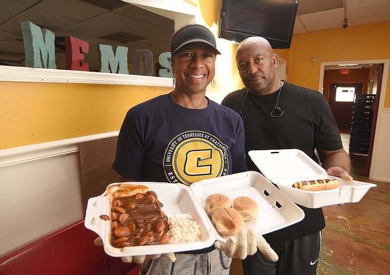 Staff photo by Matt Hamilton/ Mona and Al Hammonds hold a hot dog and a chopped wiener plate at Memo's on Thursday.