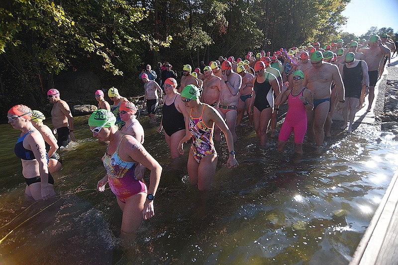 Staff photo by Matt Hamilton / Swimmers enter the water before the start of the Swim the Suck race at the Suck Creek boat ramp on the Tennessee River.