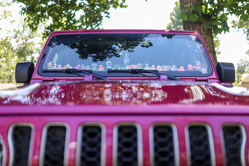 Staff photo by Olivia Ross / Rubber ducks line the length of the dashboard of Teresa Atkins Jeep Wrangler.
