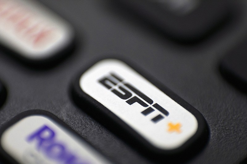FILE - A button for ESPN+ is on a remote control in Portland, Ore., Aug. 13, 2022. ESPN chairman Jimmy Pitaro said Tuesday, July 25, 2023, it is possible the network could take on a sports league as a minority partner as the network continues to transition from a cable channel to a digital company. (AP Photo/Jenny Kane, File)