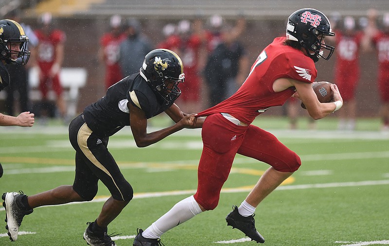 Staff photo by Matt Hamilton / Lookout Valley's Devon Cooper tries to hang on to Signal Mountain's Blake Wolfhard after he caught a pass during a jamboree matchup at Finley Stadium on Aug. 11, 2022.