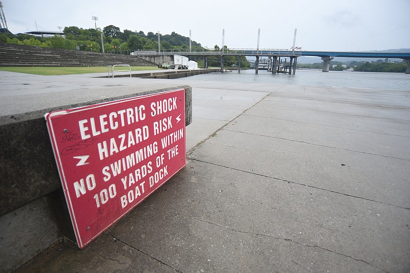Staff Photo by Matt Hamilton/ Warning signs are seen along the Tennessee riverfront on Aug. 3.