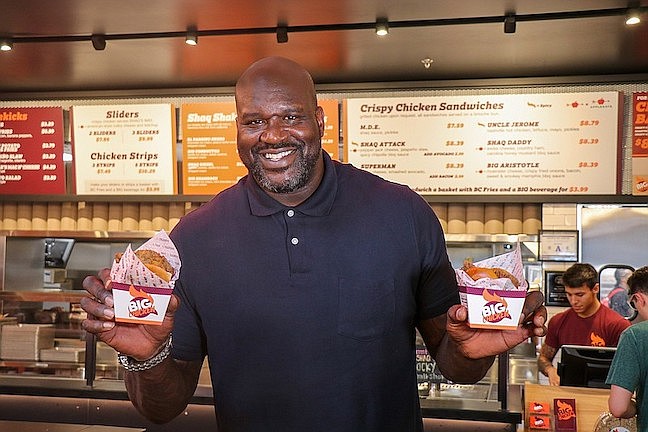 Contributed Photo / Hall of Fame basketball star Shaquille ONeal displays chicken sandwiches at Big Chicken. Franchisee Jim Richards plans to build 10 of the Big Chicken outlets in Tennessee, including new Big Chicken restaurants scheduled to open in November in Hixson and on Broad Street downtown.