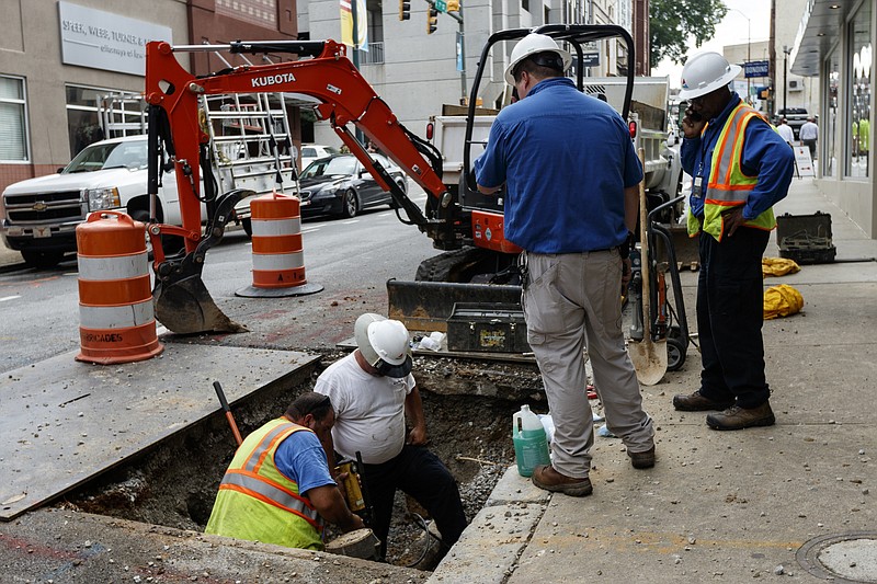 Staff photo / Workers with Chattanooga Gas repair a gas line after a gas leak in front of 14 East Seventh Street caused the evacuation of multiple nearby buildings in 2017. The leak was caused by a construction crew that struck a gas line beneath the street.