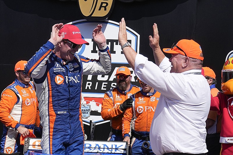 AP photo by Darron Cummings / Chip Ganassi Racing driver Scott Dixon, left, celebrates with the team owner after winning Saturday's Gallagher Grand Prix on the road course at Indianapolis Motor Speedway. Dixon's 54th career win was also his 200th podium finish, and it came in his record-breaking 319th consecutive IndyCar start.