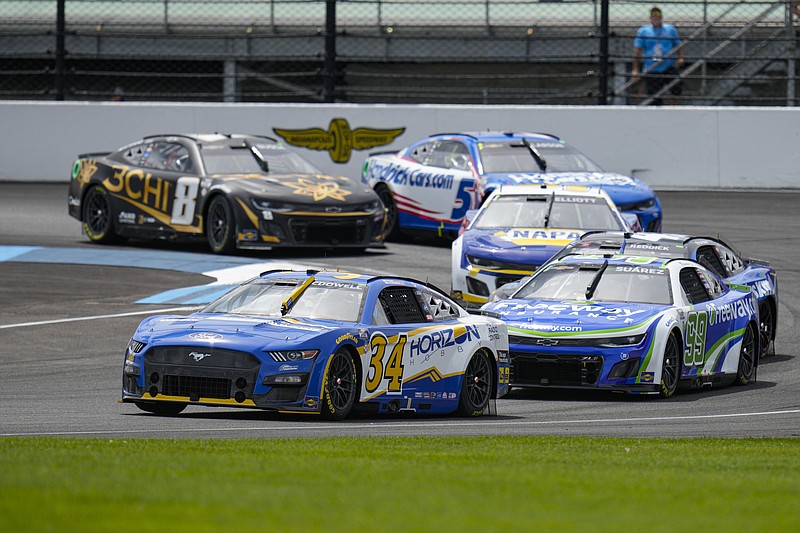 AP photo by Michael Conroy / Michael McDowell leads Daniel Suarez through the first of 14 turns on the Indianapolis Motor Speedway road course during Sunday's NASCAR Cup Series race at the track known as the Brickyard.