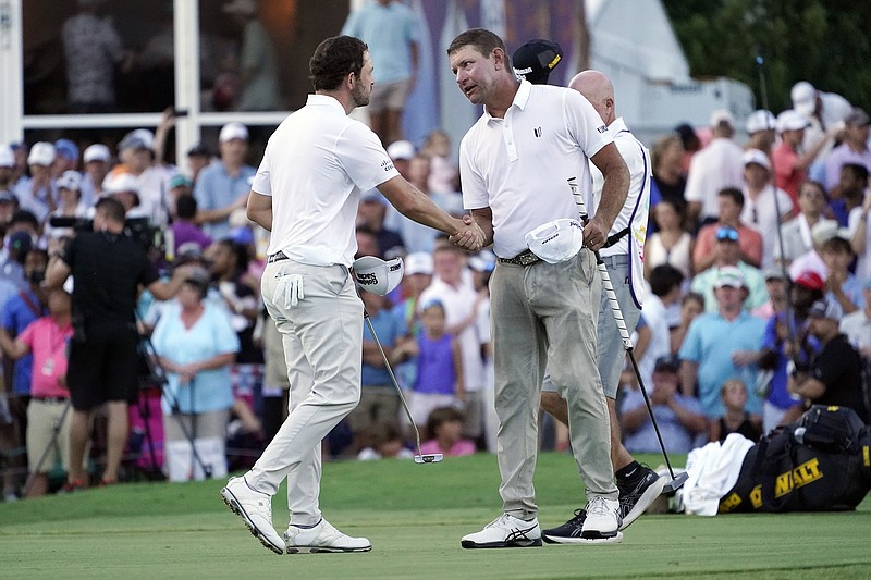 AP photo by George Walker IV / Lucas Glover, right, shakes hands with Patrick Cantlay on the 18th green at TPC Southwind after Glover won the FedEx St. Jude Championship in a playoff Sunday in Memphis. It was the opening event of the PGA Tour's postseason and Glover's second straight victory.