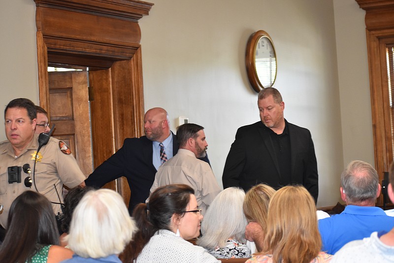Staff Photo by Andrew Wilkins / Daniel Vaughn of Ringgold, center, is escorted into a Catoosa County courtroom to hear the verdict on six charges related to a shooting after a road rage incident. He was found not guilty on all charges.