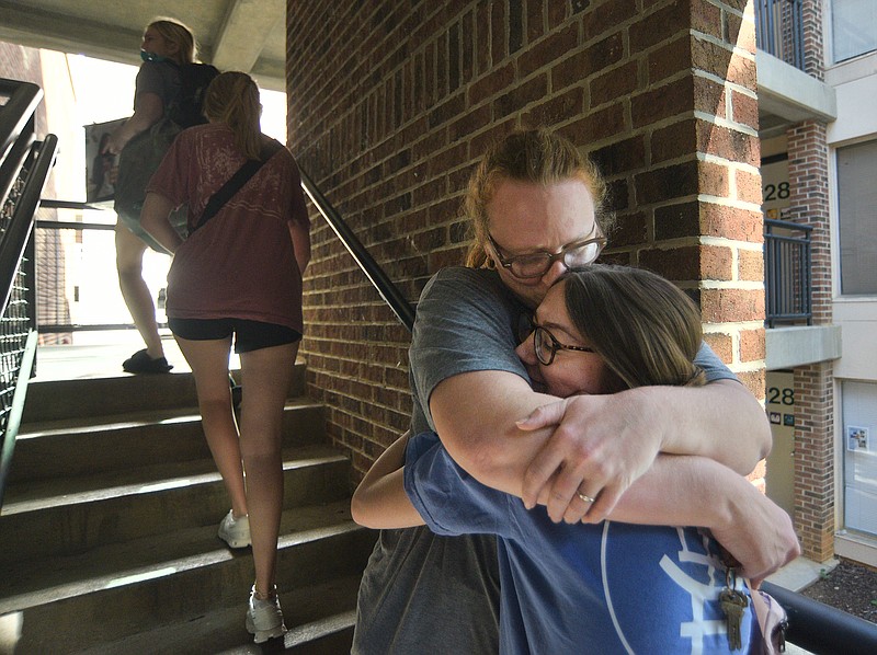 Staff photo by Matt Hamilton/ Nashville resident Malarie Sherman stops to hug her daughter Zoë Sherman on the stairs in Boling Apartments during “Operation Move In” on the campus of the University of Tennessee at Chattanooga on Thursday. Thursday was reserved for moving in by transfers and freshmen and was the first day for moving into campus housing.