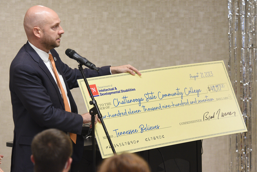 Staff Photo by Matt Hamilton / Brad Turner, commissioner of the Department of Intellectual and Developmental Disabilities, presents a check at Chattanooga State Community College on Monday.