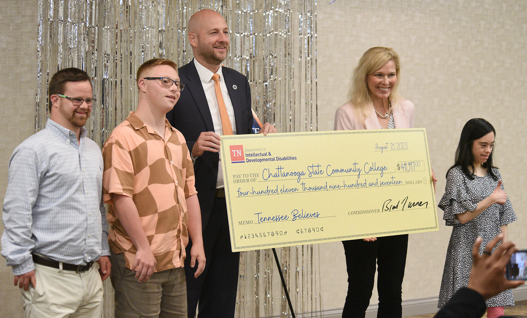 Staff Photo by Matt Hamilton/ Brad Turner, commissioner of the Department of Intellectual and Developmental Disabilities, presents a check to school President Rebecca Ashford, with students Jason Rogers, left, Luka Hyde and Anna Frierson, right, at Chattanooga State Community College on Monday.