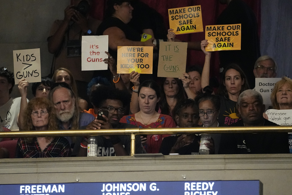 People in the gallery hold signs in support of gun reform during a special session of the state legislature Monday, Aug. 21, 2023, in Nashville, Tenn. (AP Photo/George Walker IV)