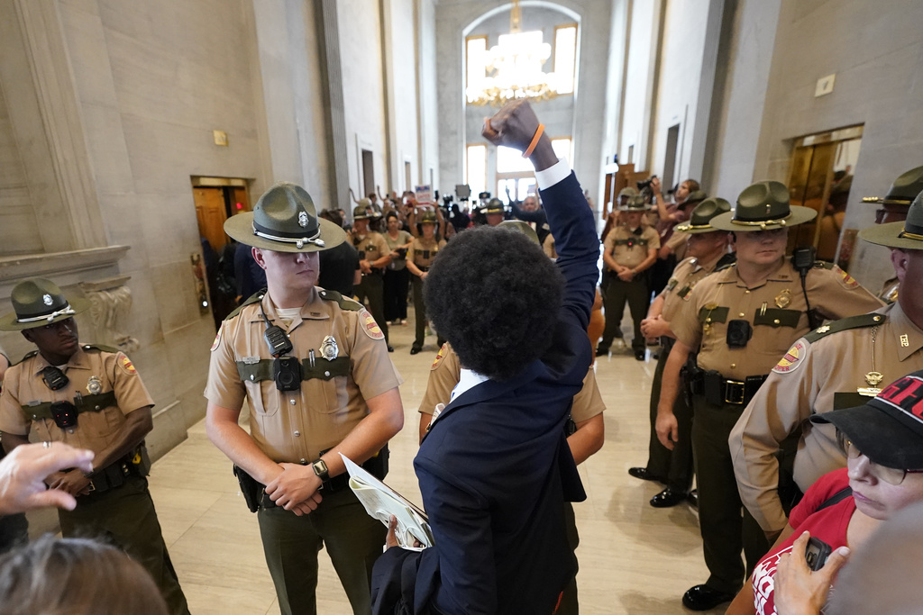 Rep. Justin J. Pearson, D-Memphis, raises his fist to supporters as he leaves the House chamber after a special session of the state legislature Monday, Aug. 21, 2023, in Nashville, Tenn. (AP Photo/George Walker IV)
