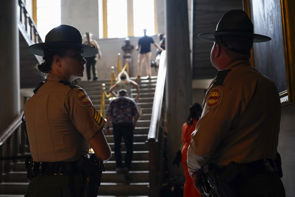 Tennessee State Troopers stand guard as people file into the state Capitol before a special session of the legislature Monday, Aug. 21, 2023, in Nashville, Tenn. (AP Photo/George Walker IV)