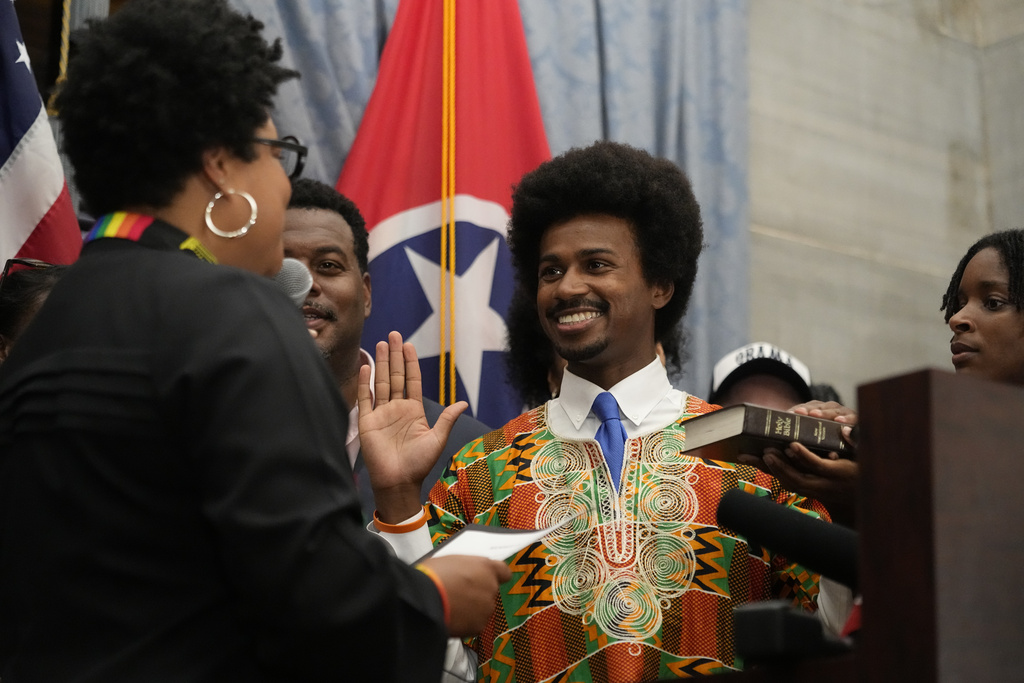 Rep. Justin J. Pearson, D-Memphis, center, takes his oath of office before a special session of the state legislature Monday, Aug. 21, 2023, in Nashville, Tenn. (AP Photo/George Walker IV)