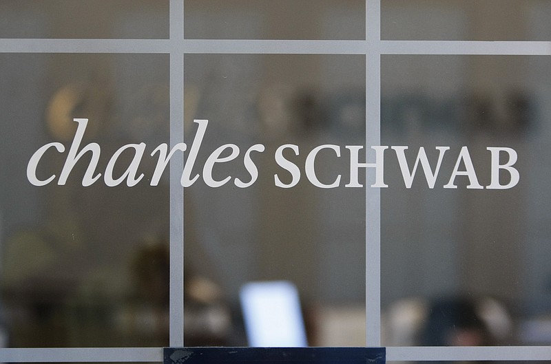 FILE - This July 14, 2010, file photo, shows a Charles Schwab office in Oakland, Calif. Charles Schwab plans to cut jobs and close or downsize some corporate offices as part of company efforts to reduce operating costs, the financial services firm said in a Monday, Aug. 21, 2023 regulatory filing. (AP Photo/Paul Sakuma, File)