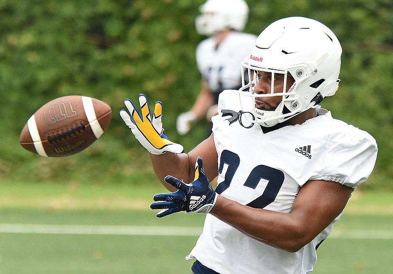 Staff photo by Matt Hamilton/ UTC running back Lance Jackson catches a pass during an Aug. 3 practice at Scrappy Moore Field. New UTC running backs coach D.J. Knox hopes to be able to take advantage of a deep position group that could help the offense open up by doing more than just take handoffs.