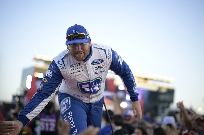 AP photo by Phelan M. Ebenhack / RFK Racing's Chris Buescher slaps hands with spectators during driver introductions before Saturday's NASCAR Cup Series race at Daytona International Speedway. Buescher won three of the final five races in the regular season, including Saturday's finale.