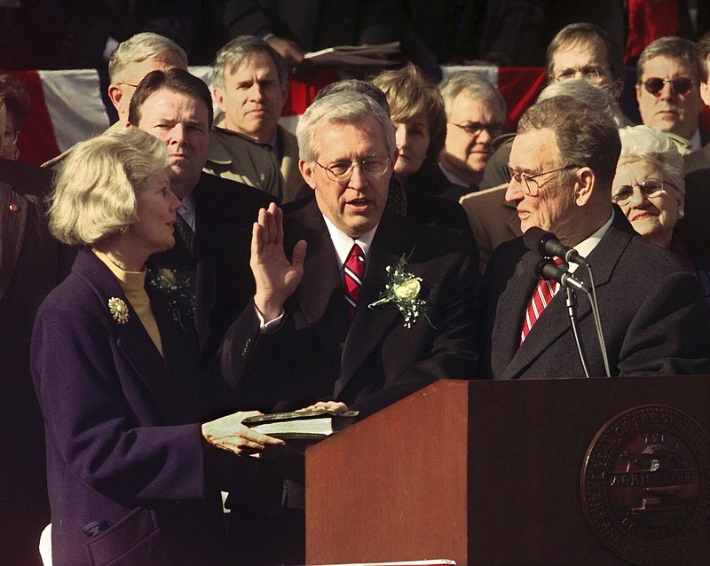 AP File Photo/Mark Humphrey / Tennessee Gov. Don Sundquist is sworn in by Lt. Gov. John Wilder, right, for his second term in Nashville on Jan. 16, 1999. Holding the Bible at left is Gov. Sundquist's wife, Martha.