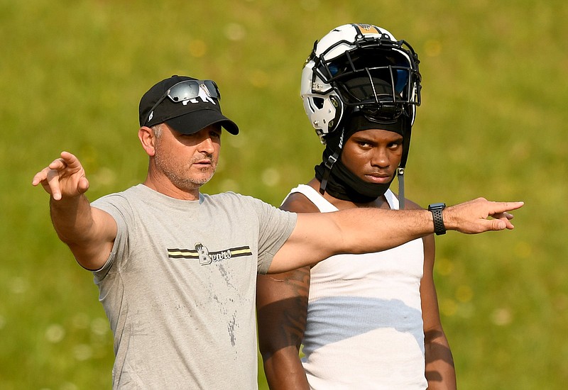 Staff photo by Robin Rudd / Boo Carter, right, listens as Bradley Central coach Damon Floyd explains a defensive setup during a June 6 practice.