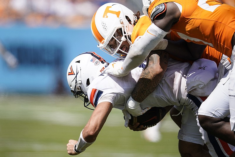 AP photo by George Walker IV / Tennessee defensive lineman Tyler Baron sacks Virginia quarterback Tony Muskett in the second half of Saturday's season opener for both teams at Nashville's Nissan Stadium. Tennessee dominated defensively in a 49-13 win against the Cavaliers.