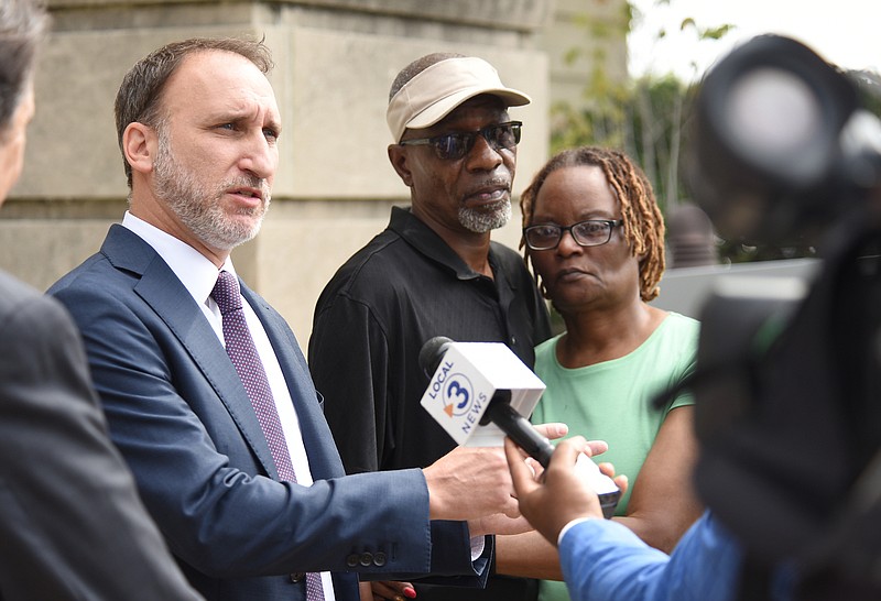 Staff Photo By Matt Hamilton / Adrian and Gloria Lewis, right, look on as attorney Jonathan Grunberg speaks during a news conference on the steps of City Hall on Wednesday concerning the police shooting of Roger Heard, Mrs. Lewis's son.