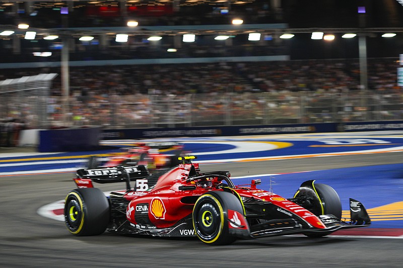 AP photo by Vincent Thian / Ferrari driver Carlos Sainz navigates a turn on the Marina Bay Circuit while racing in Formula One's Singapore Grand Prix on Sunday.