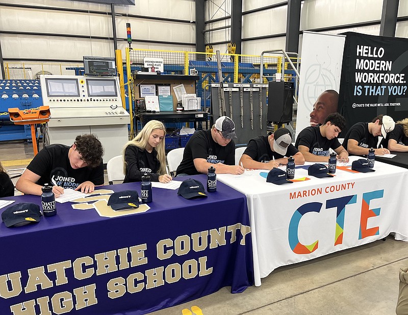 Staff Photo by Dave Flessner / High school students from Marion and Sequatchie counties sign apprenticeship agreements Wednesday to pursue training and work programs in welding and mechanical maintenance at the Valmont plant in Jasper, Tenn.